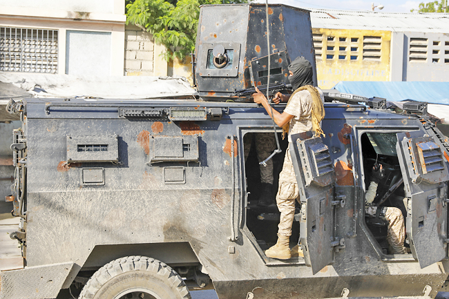 Police in Haiti struggle against gangs storming prison in latest surge ...